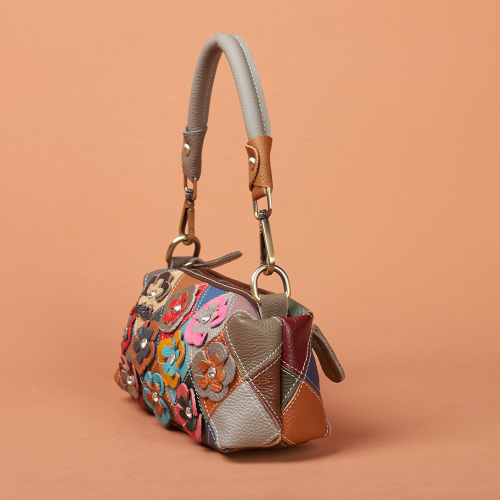 Front view of colorful leather bag with raised flower appliques