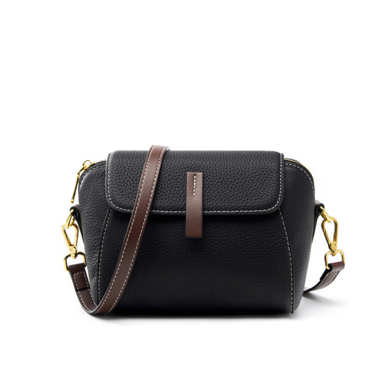 Black top-grain cowhide shell crossbody bag with brown leather pull tab and gold-tone hardware
