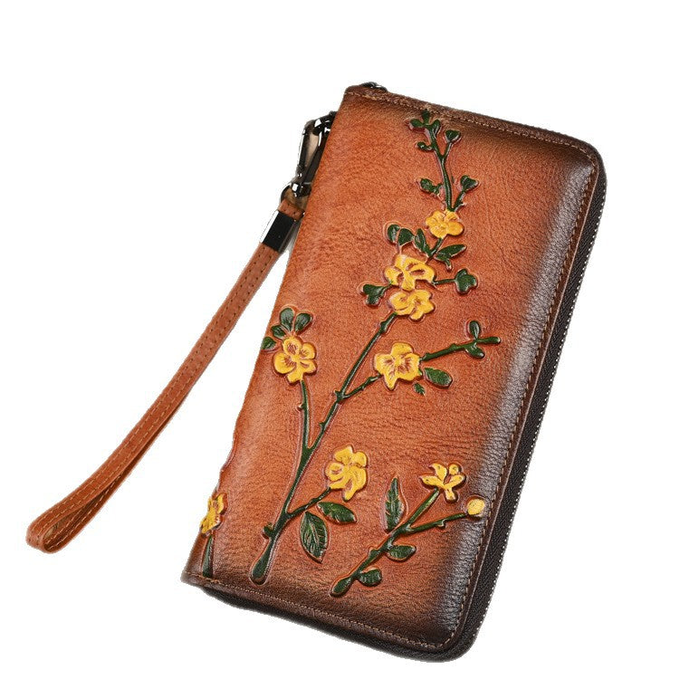 Front view of embossed flower wristlet wallet on a white background
