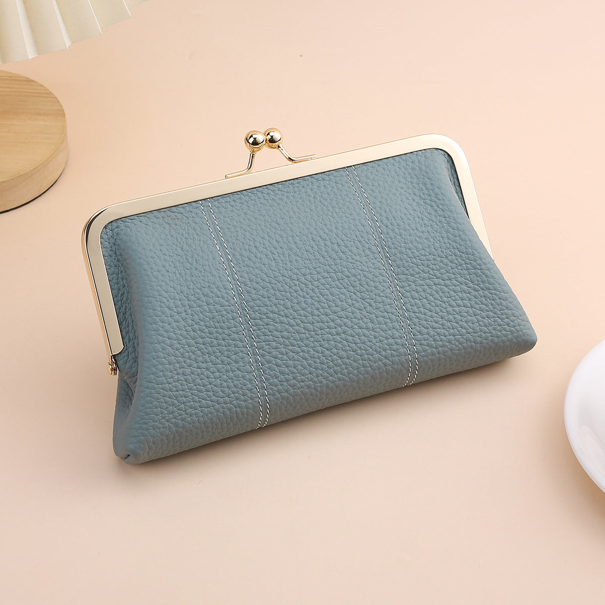 Blue cowhide clutch with polished metal frame