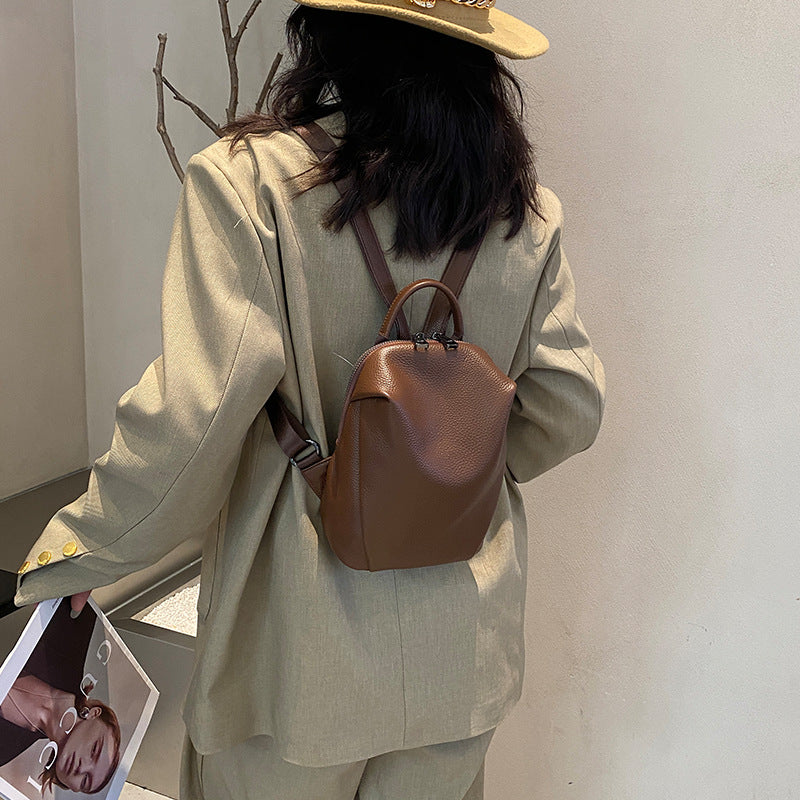 Brown mini leather backpack shown from the back