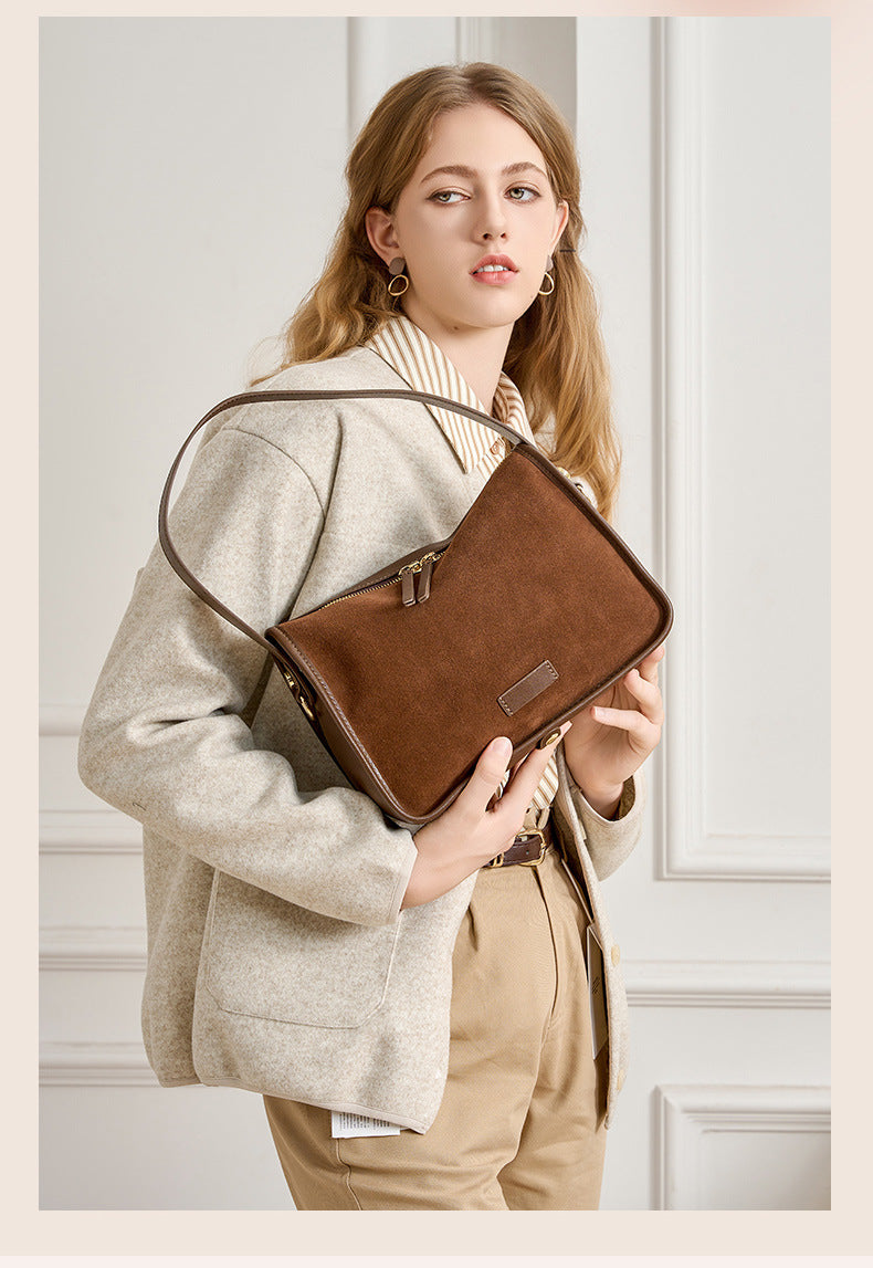 Pillow-shaped leather bag shown from an angled side view