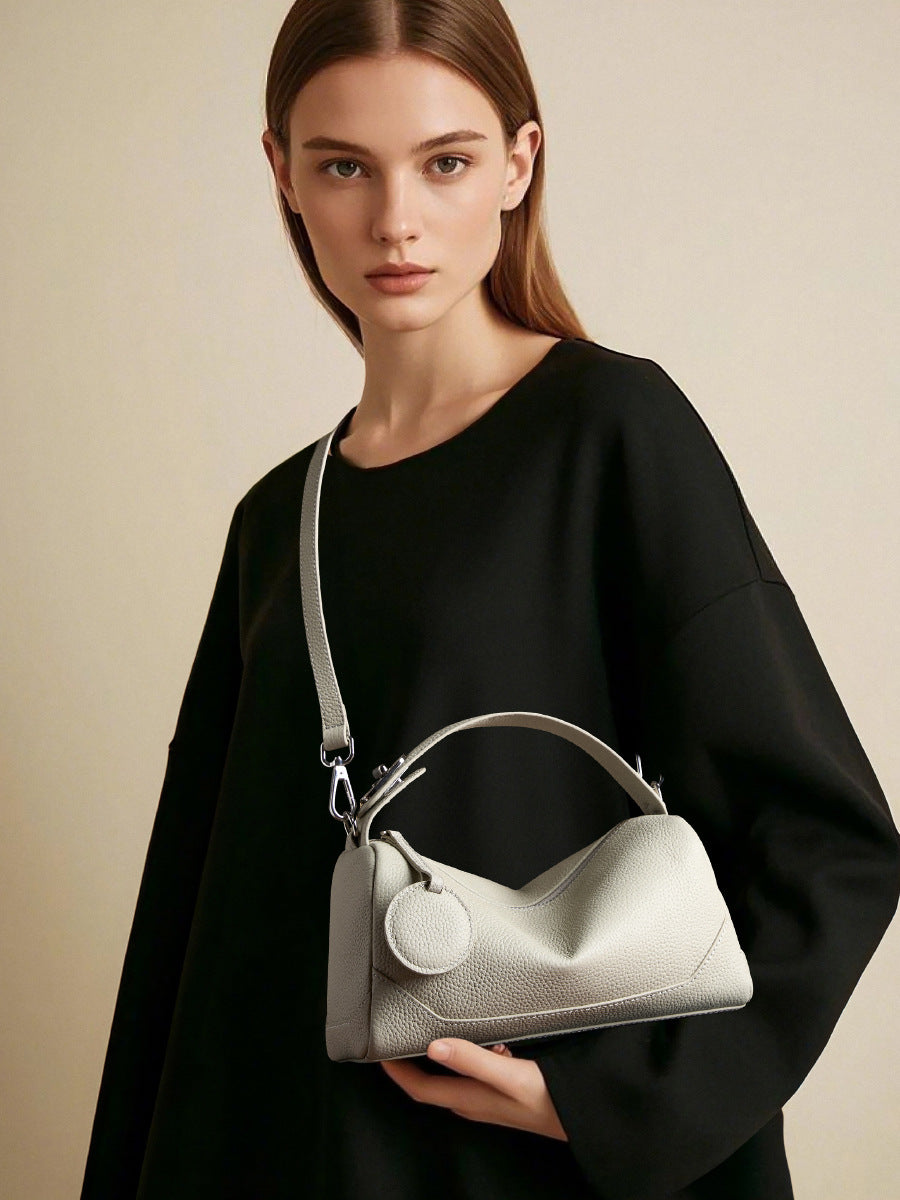 Model wearing ash white crossbody mini Boston bag with black outfit