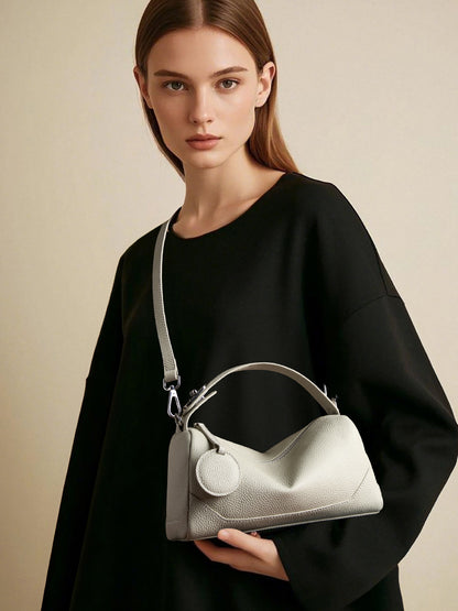 Model wearing ash white crossbody mini Boston bag with black outfit