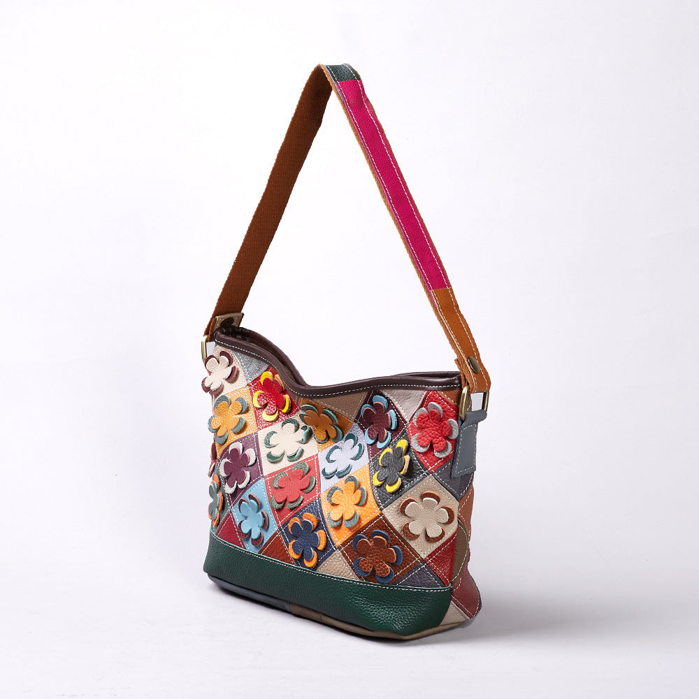 Angled view showing the floral diamond patchwork and shoulder strap