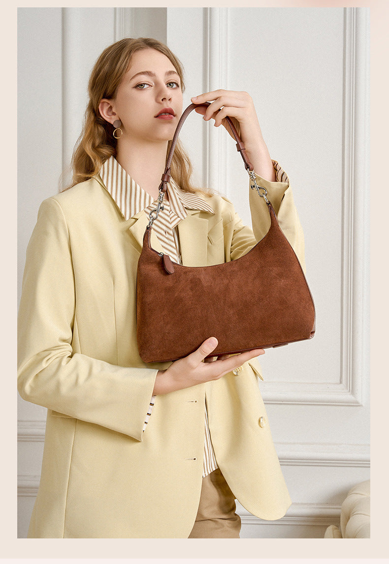 Brown shoulder bag styled with a light blazer