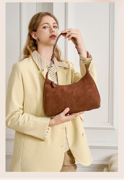 Brown shoulder bag styled with a light blazer