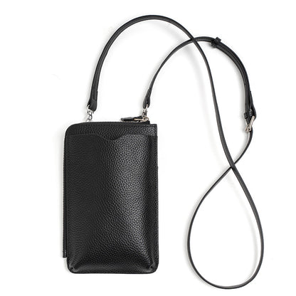 Black leather phone bag laid flat with long adjustable strap fully extended