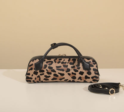 Close view of the bag's front panel and arched top handles