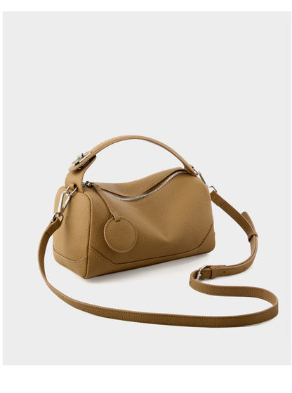 Caramel mini Boston bag shown with adjustable shoulder strap extended