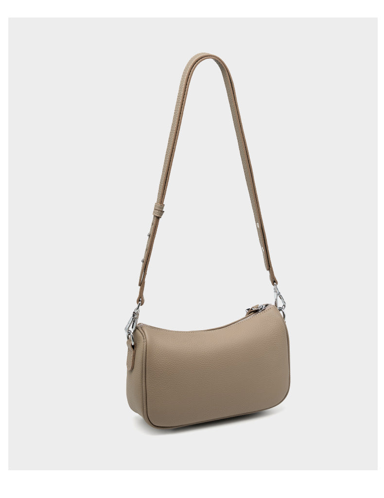 Three-quarter view of taupe bag with strap extended