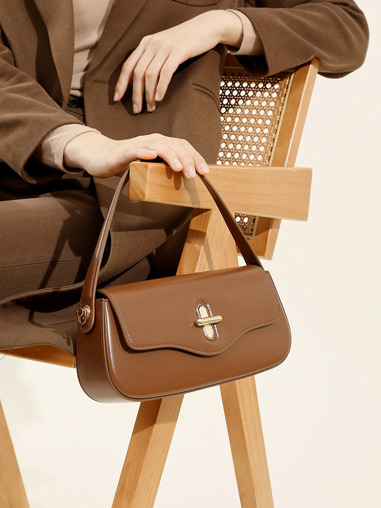 Caramel leather baguette handbag side profile showing slim silhouette
