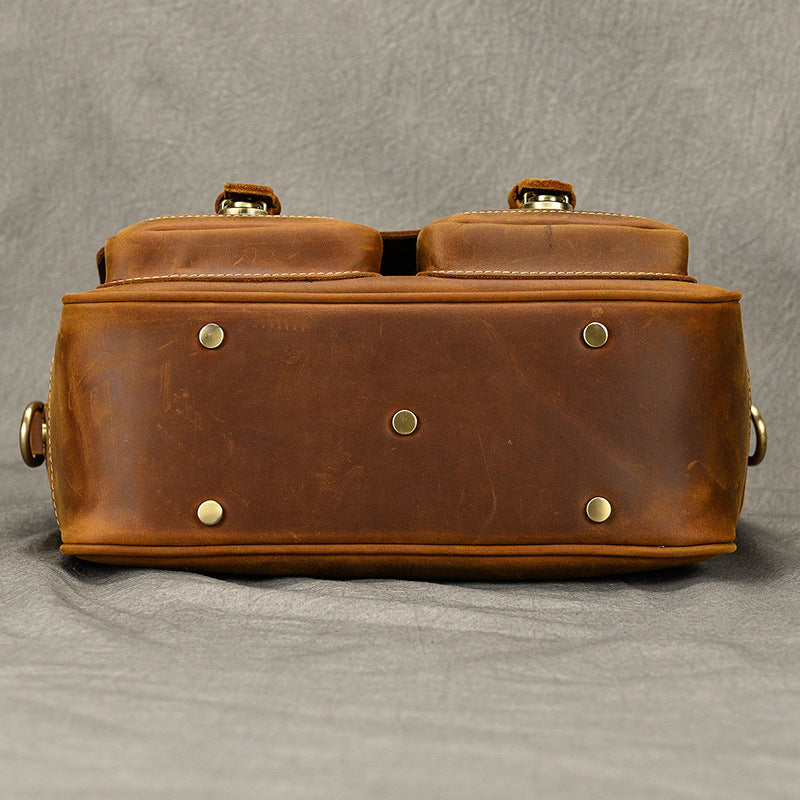 Bottom view of brown leather camera bag with protective metal feet