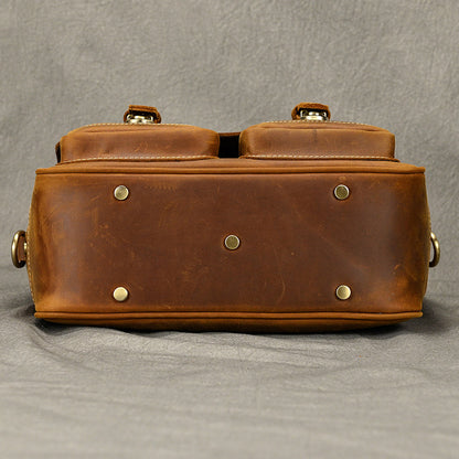 Bottom view of brown leather camera bag with protective metal feet