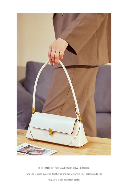White baguette bag held by strap with lifestyle styling