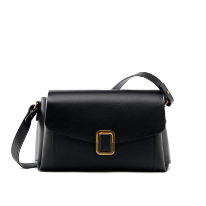 Black cowhide leather crossbody bag with gold-tone buckle on white background