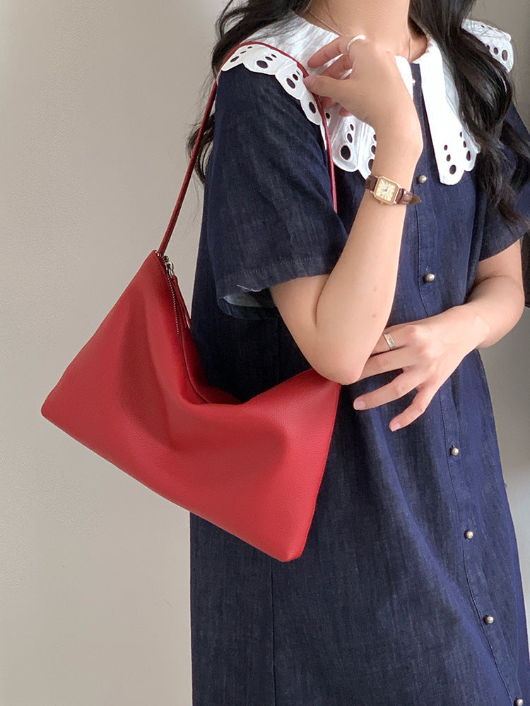 Red hobo shoulder bag styled with a navy dress