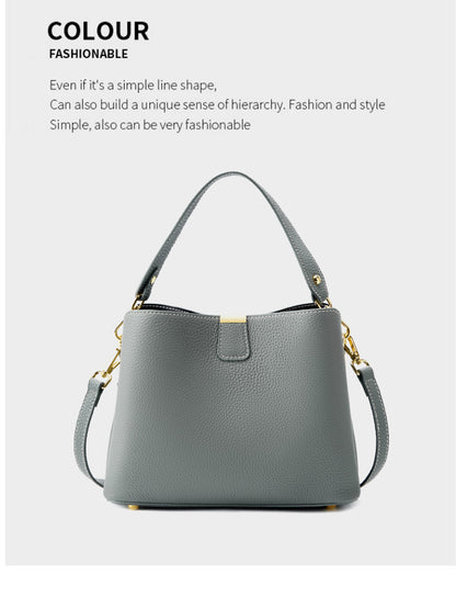 Gray leather bucket bag with its leather strap