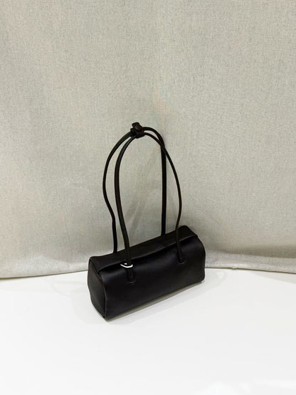Black leather shoulder bag showing its soft pillow shape