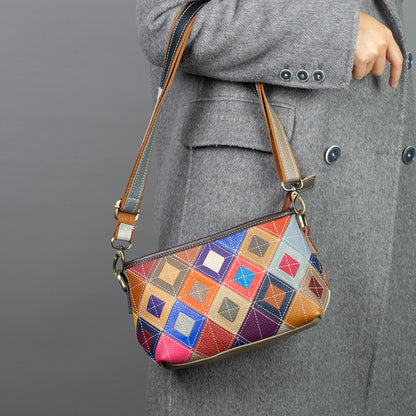 Multicolor geometric patchwork cowhide crossbody bag worn over a coat