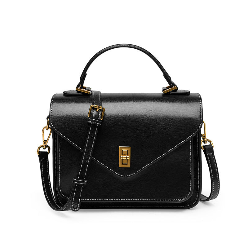 Black cowhide leather messenger crossbody bag with turn-lock flap and top handle