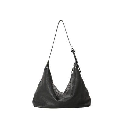 Black leather hobo bag with curved soft silhouette on white background