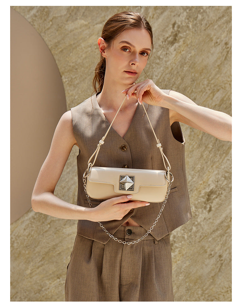 Model wearing off-white leather baguette shoulder bag, side view