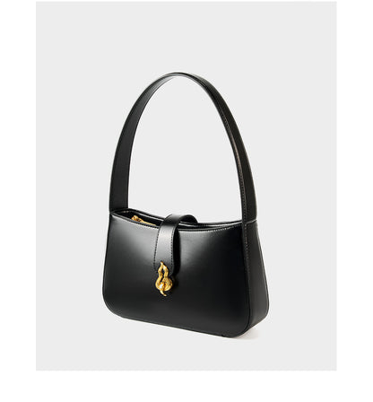 Side view of black leather shoulder bag showing flap and gourd clasp