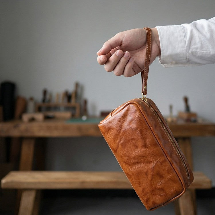 Cosmetics arranged inside a brown leather pouch
