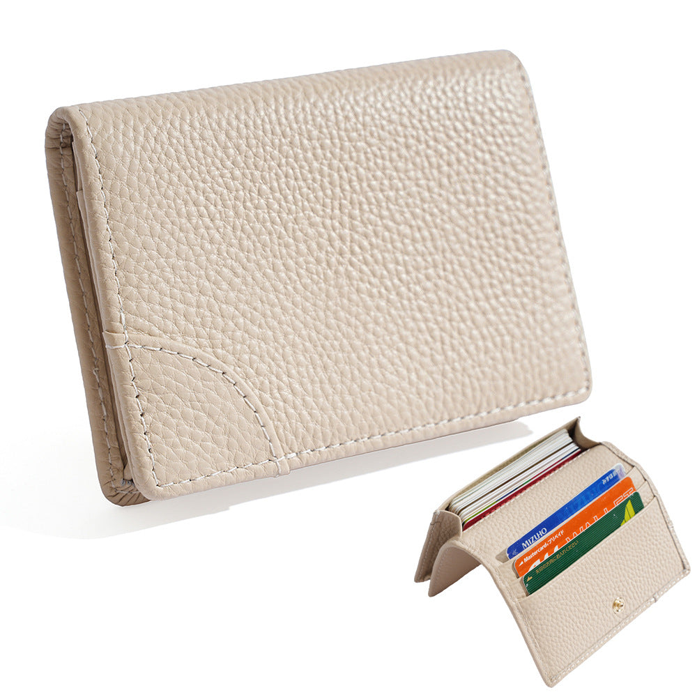 Off white pebbled cowhide leather mini bifold wallet with cards inside the slots
