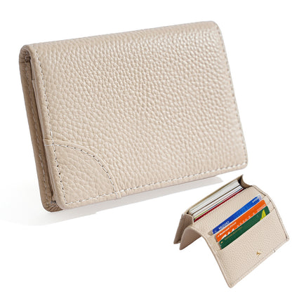 Off white pebbled cowhide leather mini bifold wallet with cards inside the slots
