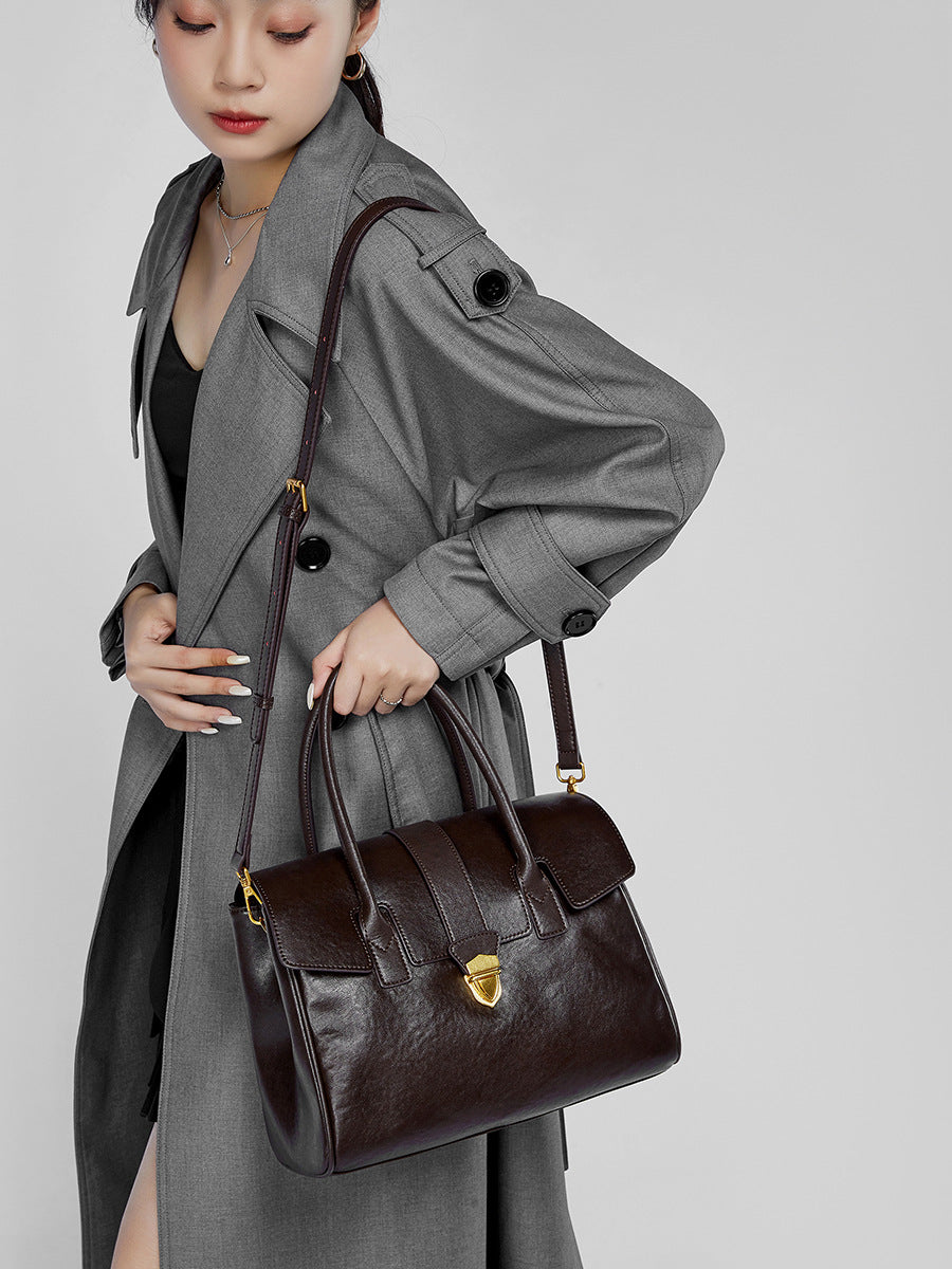 Chocolate brown leather satchel bag with top handles and shoulder strap