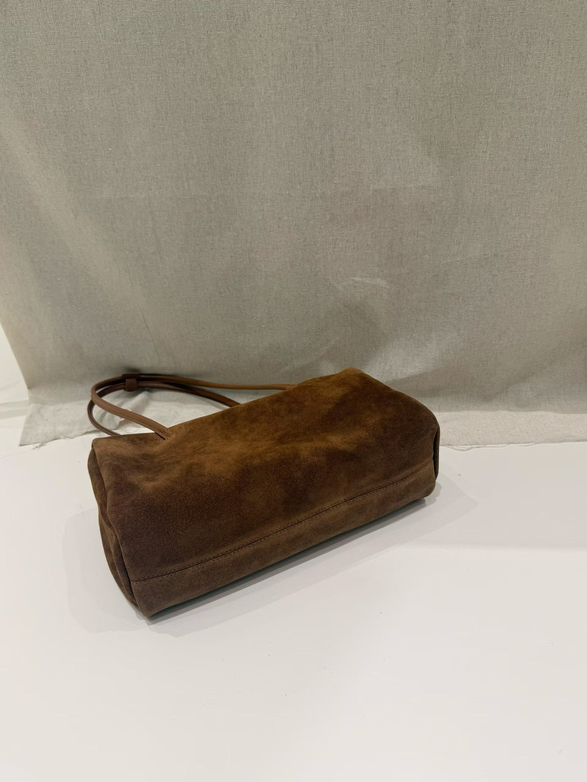 Caramel-colored tote shown standing with two handles