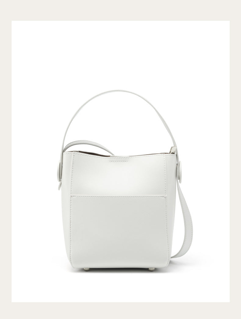Off-white cowhide bucket crossbody bag with metal feet on white background