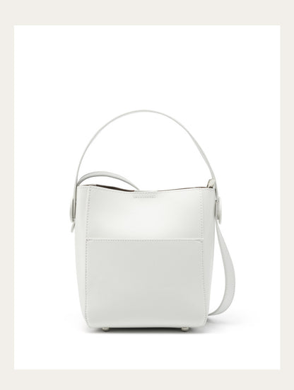 Off-white cowhide bucket crossbody bag with metal feet on white background