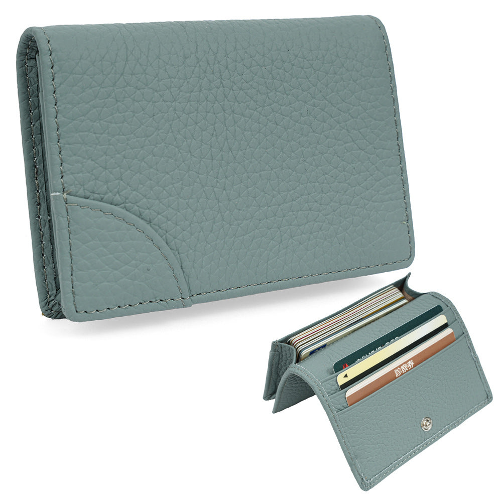 Light green pebbled cowhide leather mini wallet displaying snap closed coin pocket