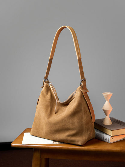 Khaki suede tote displayed on a table