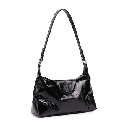 Black cowhide leather shoulder bag with adjustable strap on white background