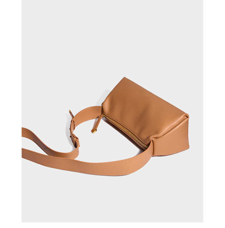 Apricot pillow crossbody bag angled view showing strap and hardware