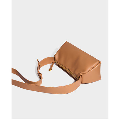 Apricot pillow crossbody bag angled view showing strap and hardware