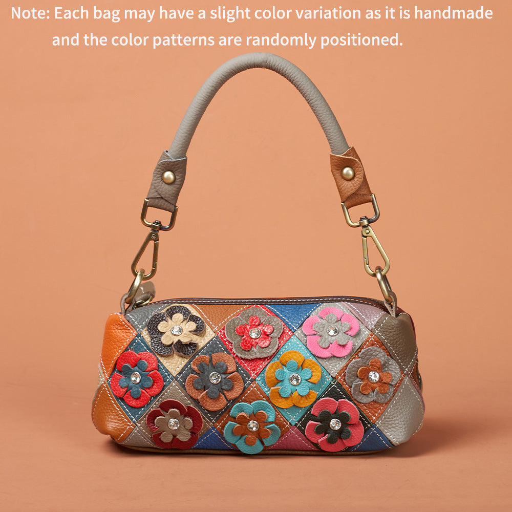 Side angle highlighting the floral appliques and bag shape