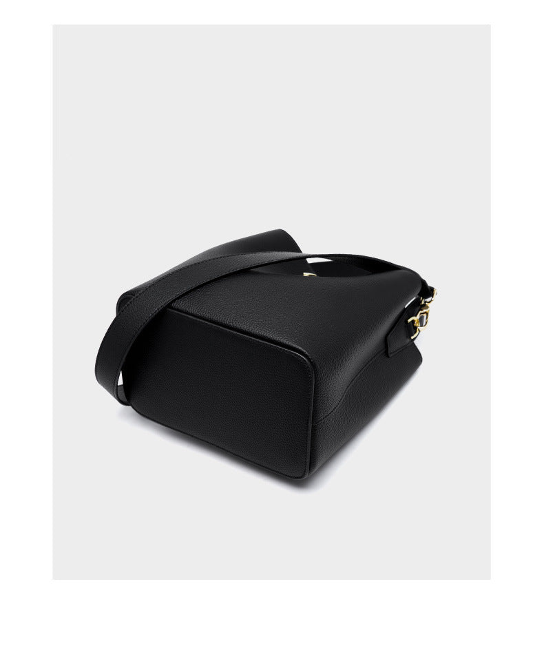 Black bucket bag bottom view showing structured base and strap