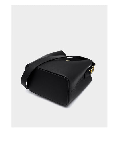 Black bucket bag bottom view showing structured base and strap