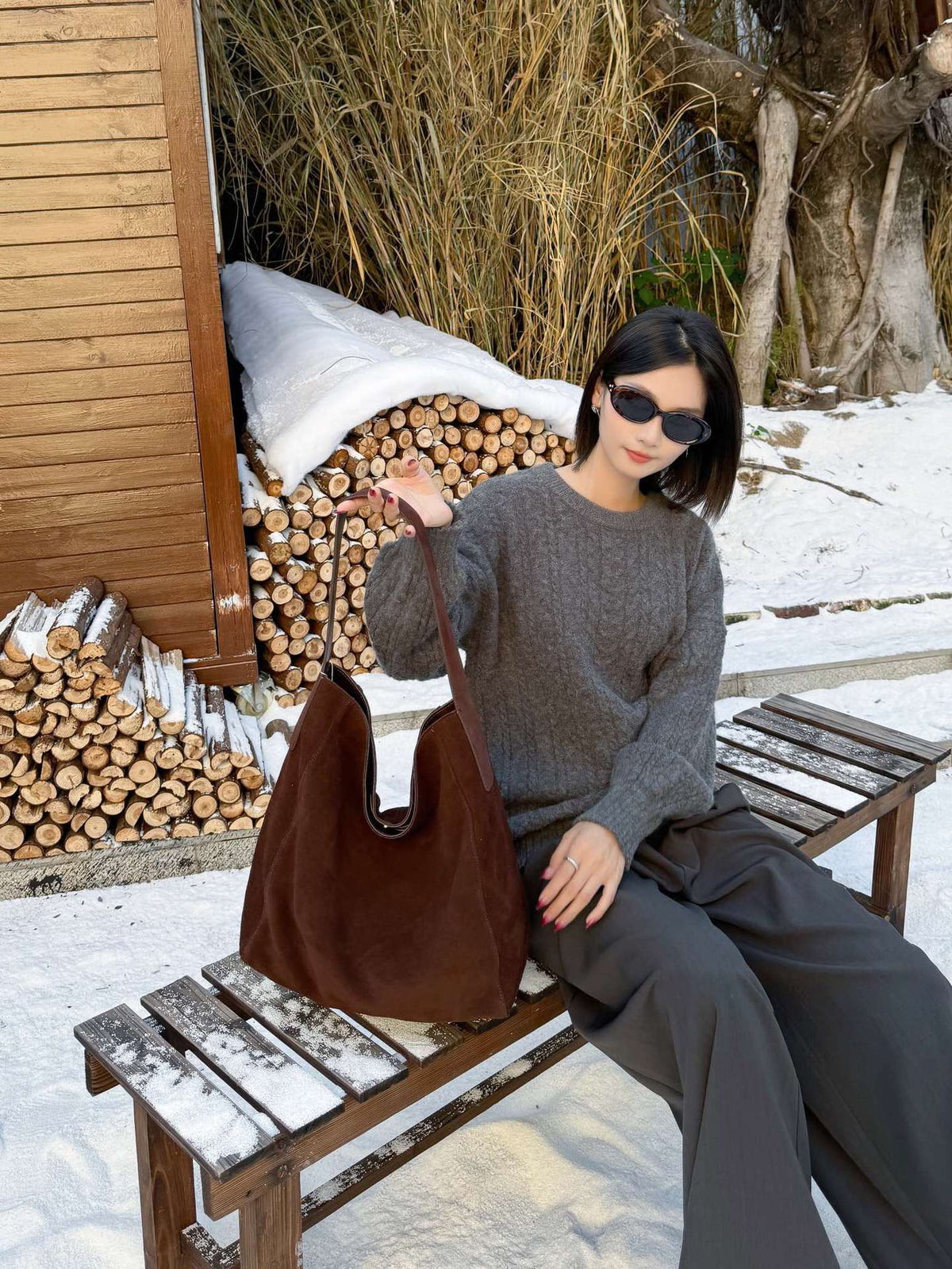 Model wearing the brown tote over one shoulder