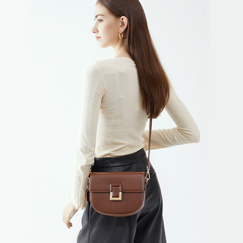 Back view of the brown saddle bag worn crossbody