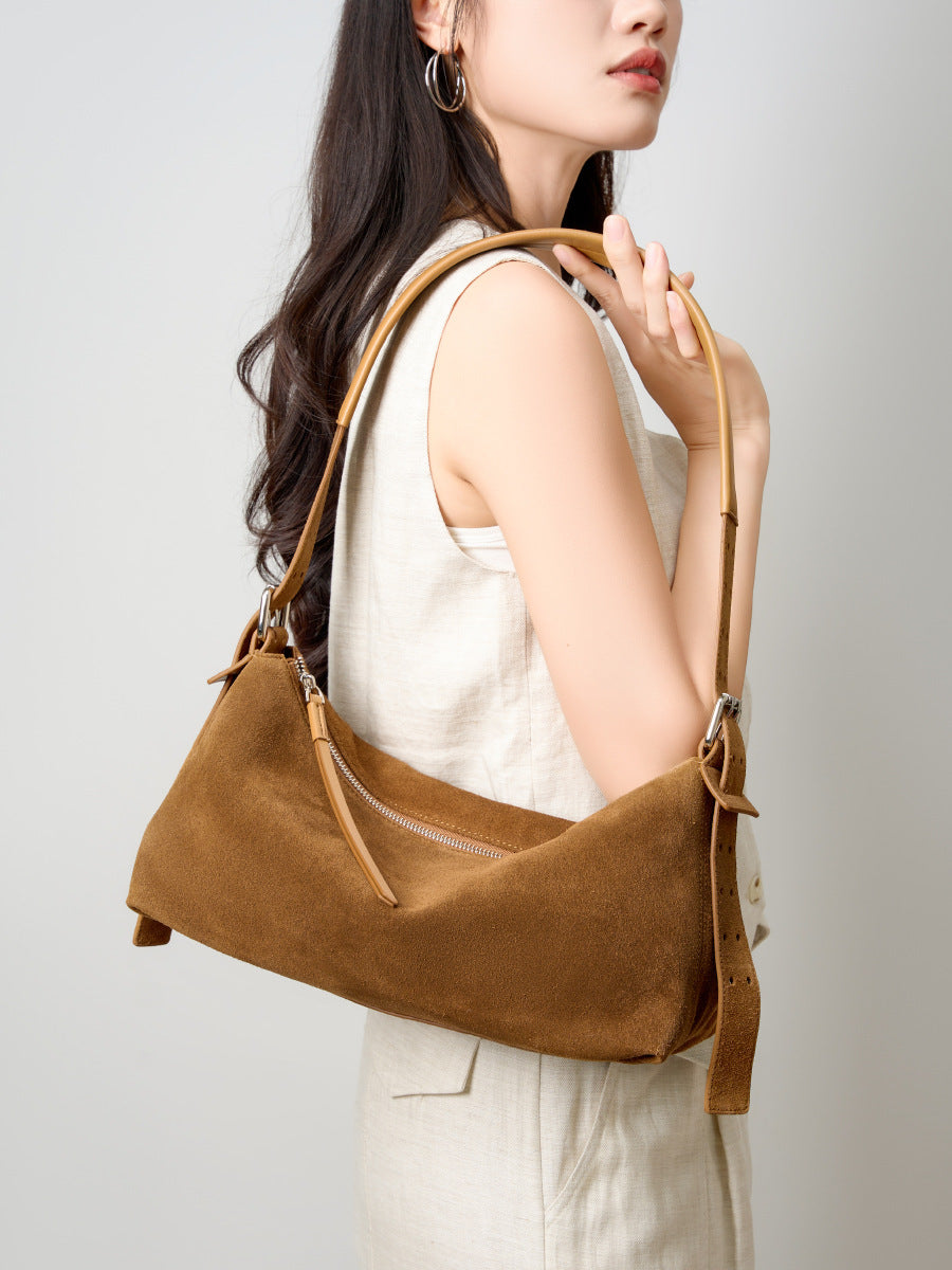 Model carrying the caramel bag over one shoulder