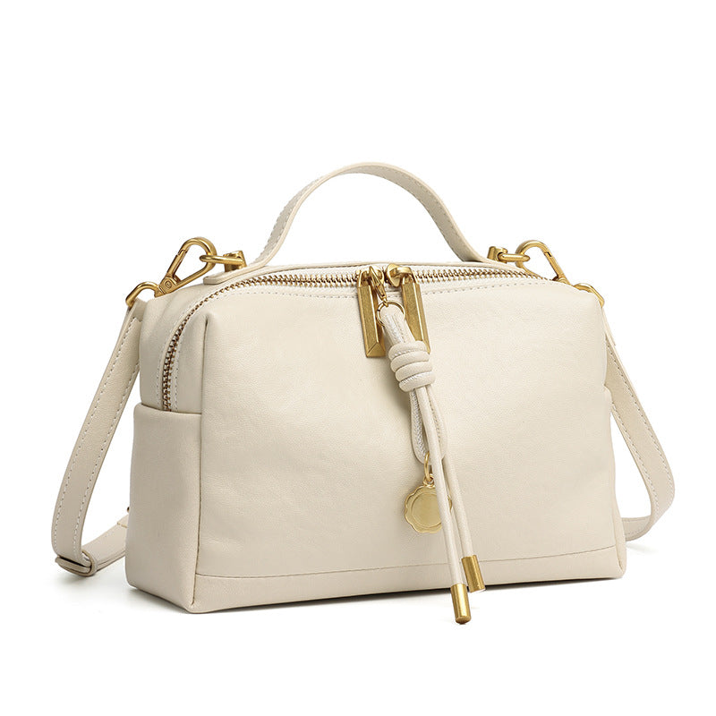 Off-white cowhide leather small handbag with top handle and adjustable strap