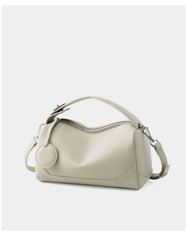 Ash white mini Boston bag front view with attached shoulder strap on white