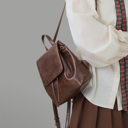 Angled side view showing the backpack shape and strap