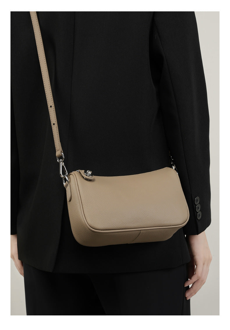 Front view of taupe crossbody bag with adjustable strap and clasp